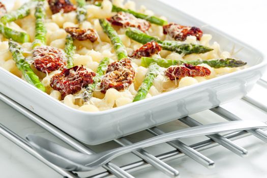 pasta baked with dried tomatoes, asparagus and pecorino cheese