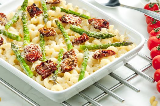 pasta baked with dried tomatoes, asparagus and pecorino cheese