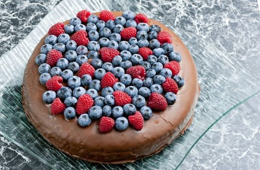 chocolate cake with raspberries and blueberries