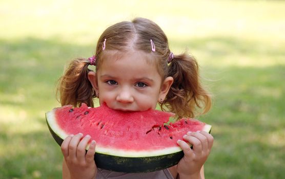 beauty little girl eat watermelon