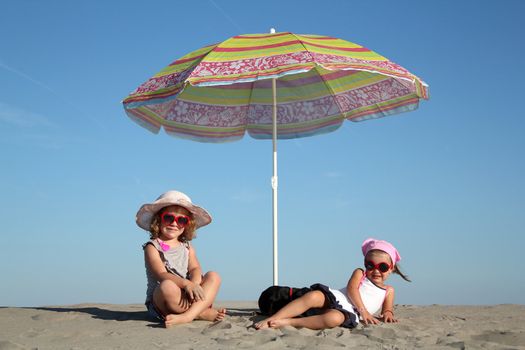 two little girl under sunshade