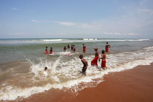 SRI LANKA, KALATURA - 08 APRIL, 2011: School of the Buddhism. Young Buddhists bathe at ocean in a break between lessons 08 april in Kalatura, Sri lanka (Ceylon)