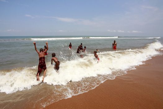 SRI LANKA, KALATURA - 08 APRIL, 2011: School of the Buddhism. Young Buddhists bathe at ocean in a break between lessons 08 april in Kalatura, Sri lanka (Ceylon)