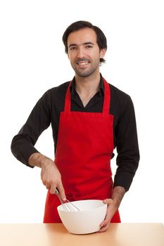 a chef stirring with a whisk in a bowl