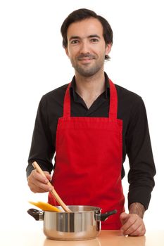 a chef stirring with a spoon in pot with spaghetti pasta