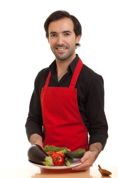 a chef presenting a bowl of vegetables