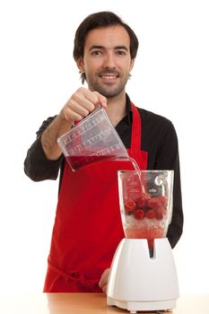 a chef pouring liquid into a blender