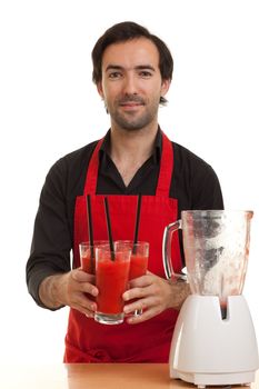 a chef holding some cocktails with a blender in front of him