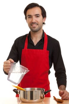 a chef pouring water into a pot with spaghetti pasta