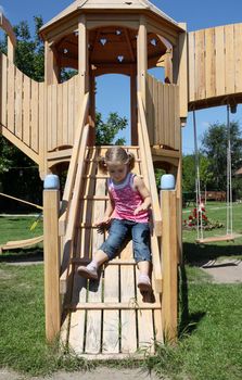 little girl fun on wooden playground