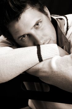 Male model in studio against black background