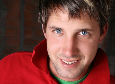 Male model against a rough brick wall background