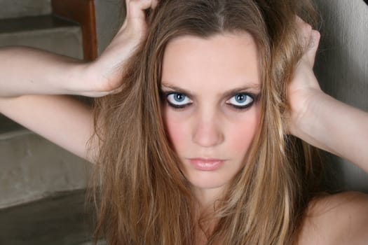 Beautiful female model with blue eyes and dark make up
