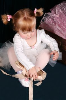 Little ballet toddler wearing a white tutu
