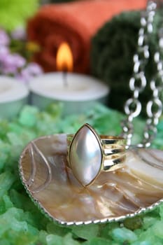 Spa Accessories in the background with a heart necklace and ring