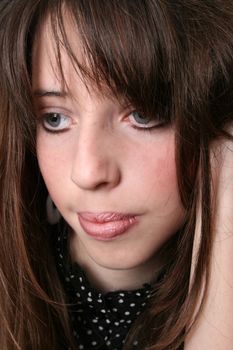 Close up of a serious looking brunette teenager 