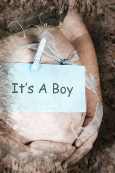 Heavily pregnant lady with a sign on her tummy