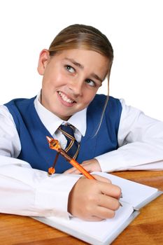 Teenage School girl busy with her homework, wearing uniform