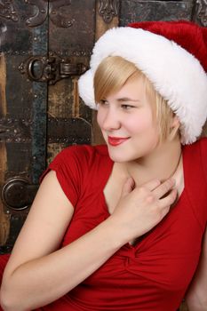 Beautiful young blond female wearing a fluffy christmas hat