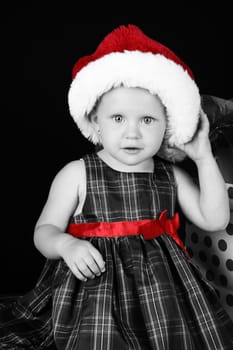 Cute caucasian toddler wearing a fluffy christmas hat