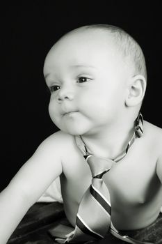 Cute caucasian baby wearing just a tie and diaper