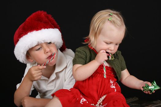 Christmas brother and sister eating Candy Canes