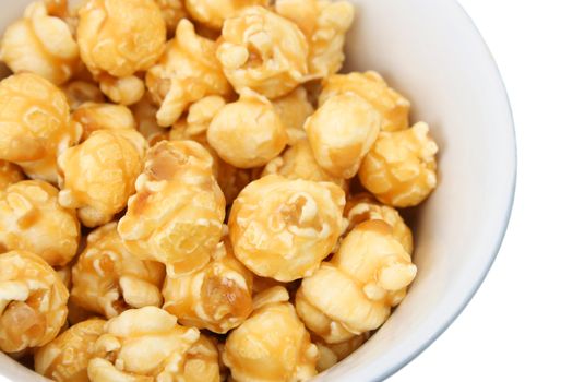 A white ceramic bowl filled with caramel popcorn
