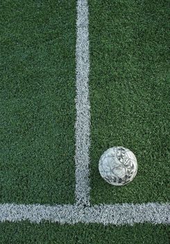 Artificial grass soccer field and old football