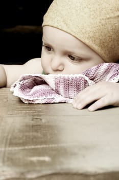 Cute baby boy outside in the garden wearing green outfit