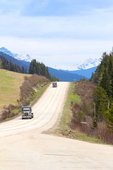 Two empty logging trucks on Alberta road, Canada