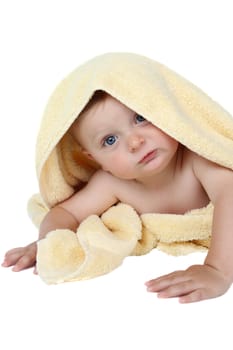 Beautiful baby boy wrapped in a soft yellow towel