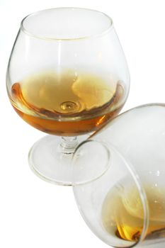 Glass of brandy over white background