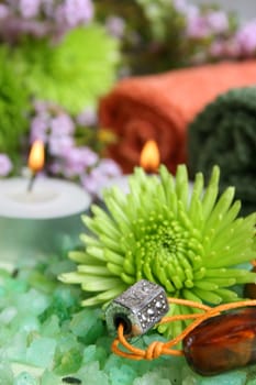 Spa Accessories setting with face cloths, jewelery and flowers 