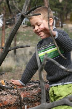 Little blond boy playing outside in the field
