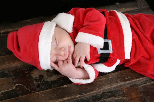 Baby boy wearing a christmas suit sleeping
