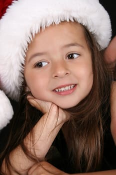 Beautiful little brunette girl dreaming about christmas