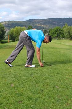 Young golfer setting up his tee-shot on the tee-box