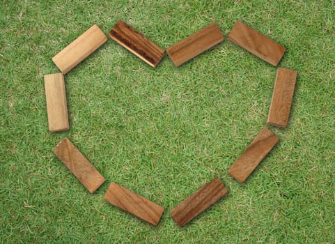 Wooden hearts on grass background