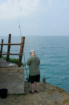 Man fishing by the sea