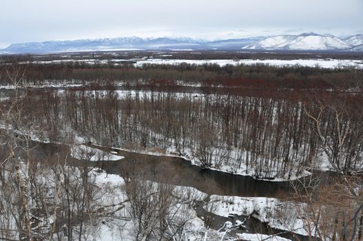 Winter landscape kamchatka with the river and hills