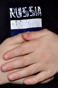 Inscription "russia" against fingers of hands of the boy