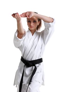 Karate. Young girl in a kimono with a white background
