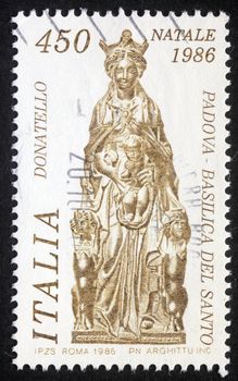 ITALY - CIRCA 1986: A greeting Christmas stamp printed in Italy shows sculpture by artist Donatelo -  Madonna with child