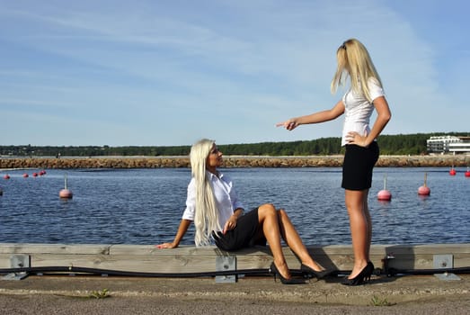 Girl arguing with another girl on the pier