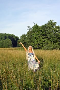 Blonde girl alone in field. Freedom.