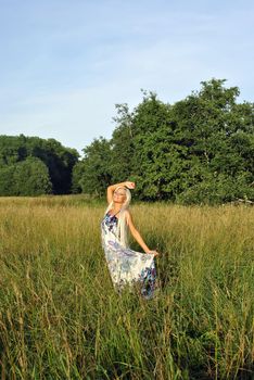 Blonde girl alone in field. Freedom.