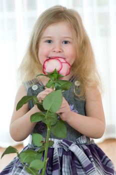 beautiful little girl with pink of rose