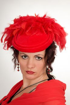Portrait of the woman in a red hat with feathers
