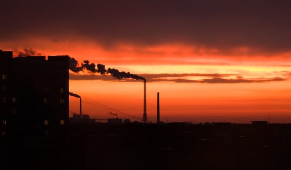  photograph of industrial buildings at sunset sky 
