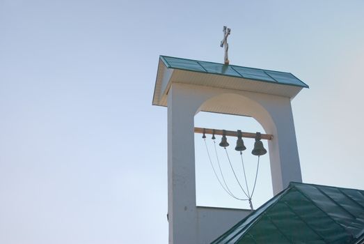 roof of the Greek church belfry against the suny sky 